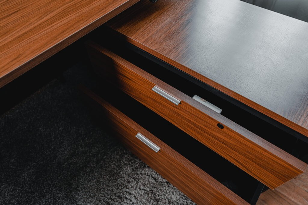 CEO office desk with sleek wooden drawers, partially open to display the smooth sliding mechanism.