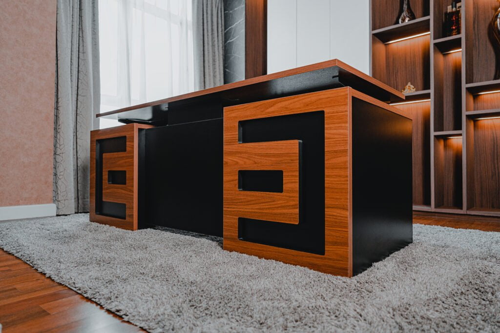 Wide shot of an executive CEO desk in a modern office, featuring a combination of wooden and black design elements.